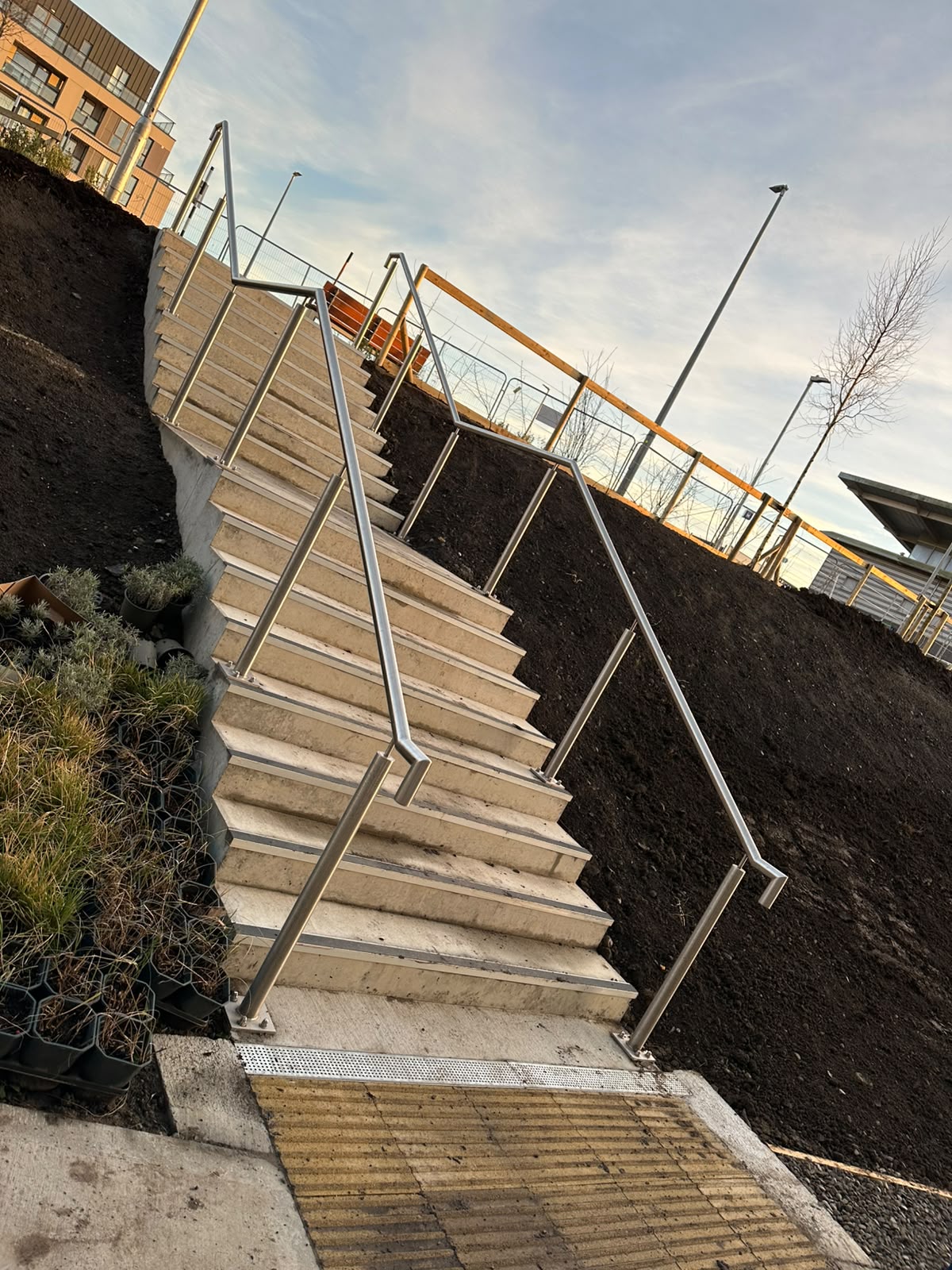 Stainless steel handrails to landscaped external steps