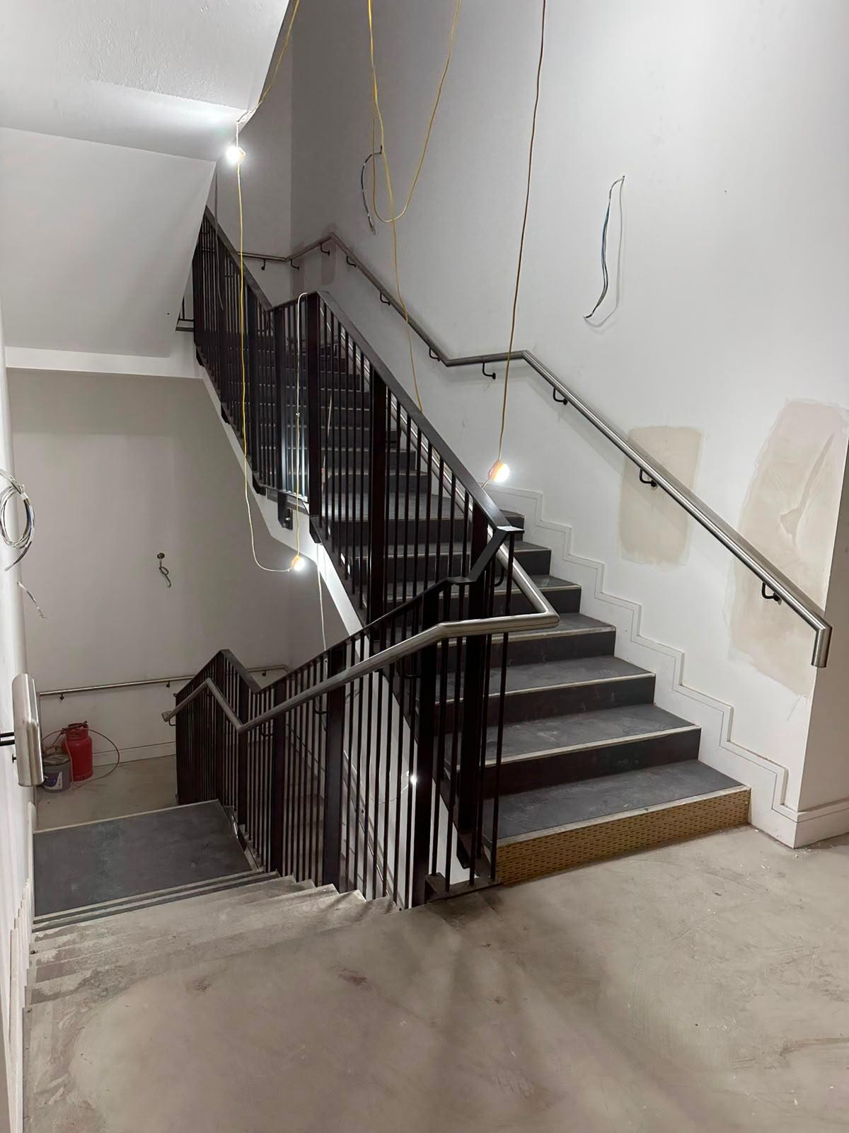 Stair balustrade being installed on site during the fit out