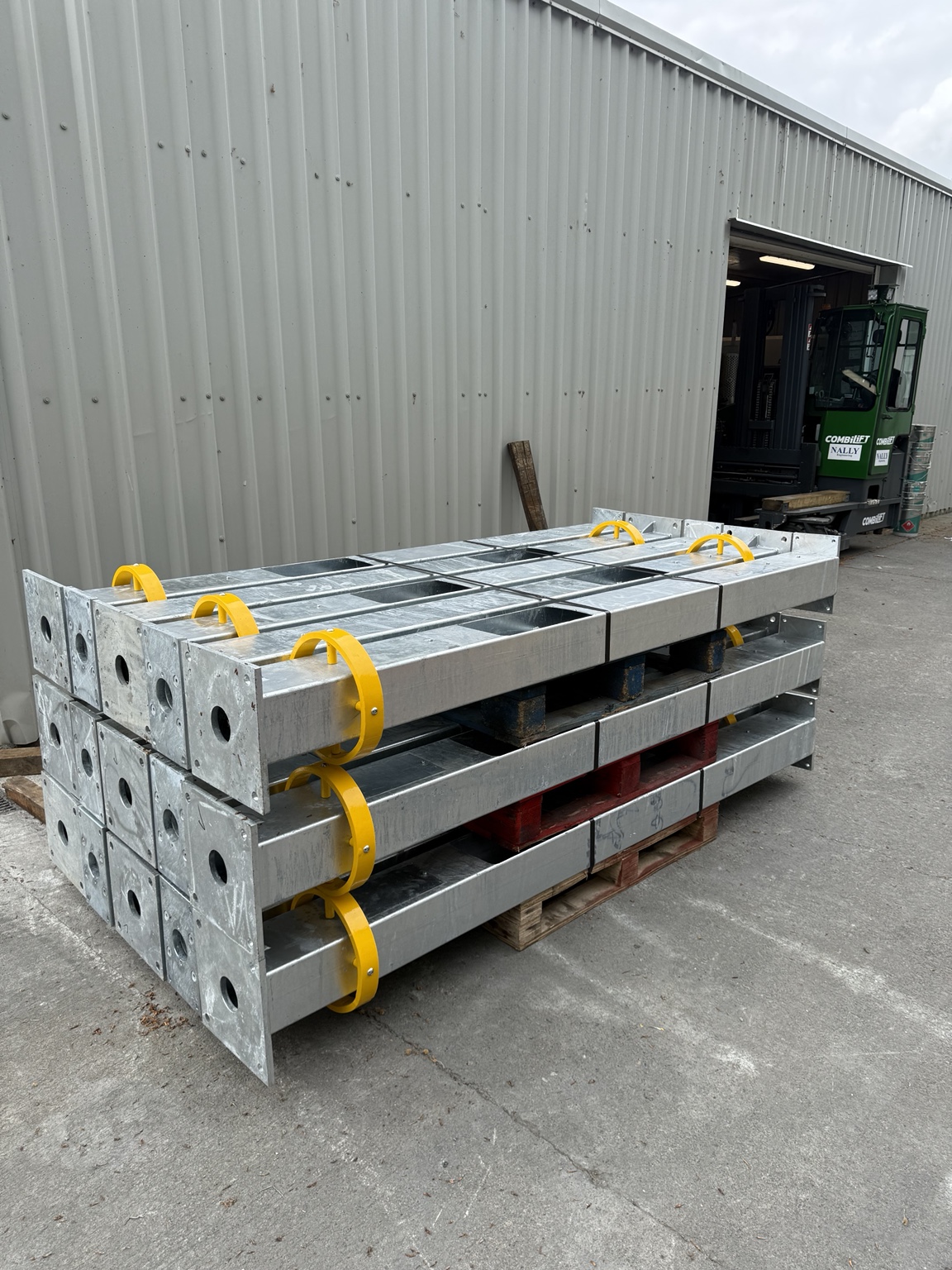 Galvanised steel help point support assemblies stacked on pallets ready for delivery to Irish Rail stations