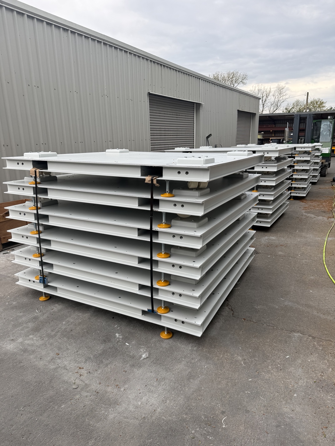 Batch production run of modular steel skid systems laid out on the workshop floor at Nally Engineering